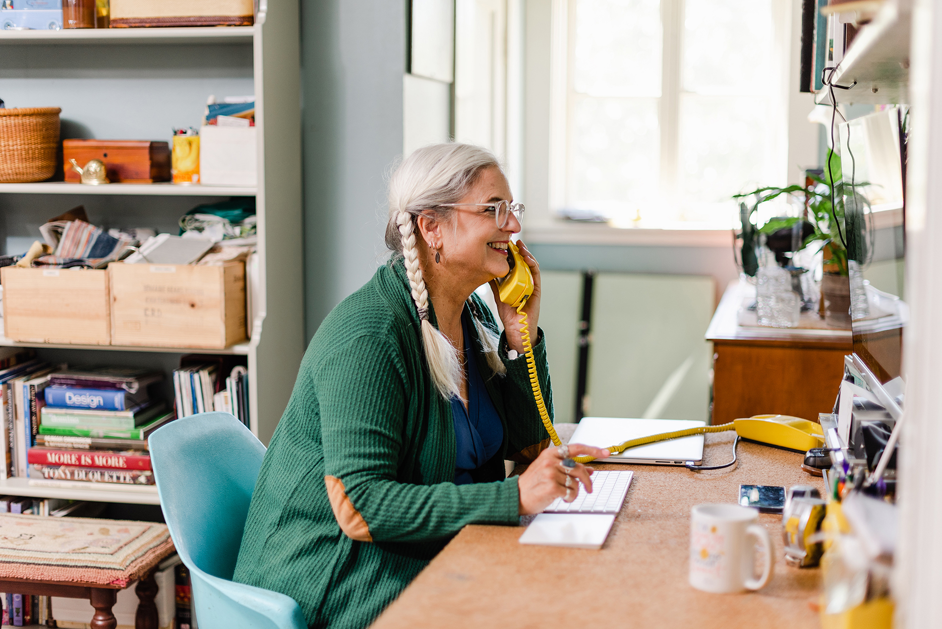 Interior designer working at colourful office desk.