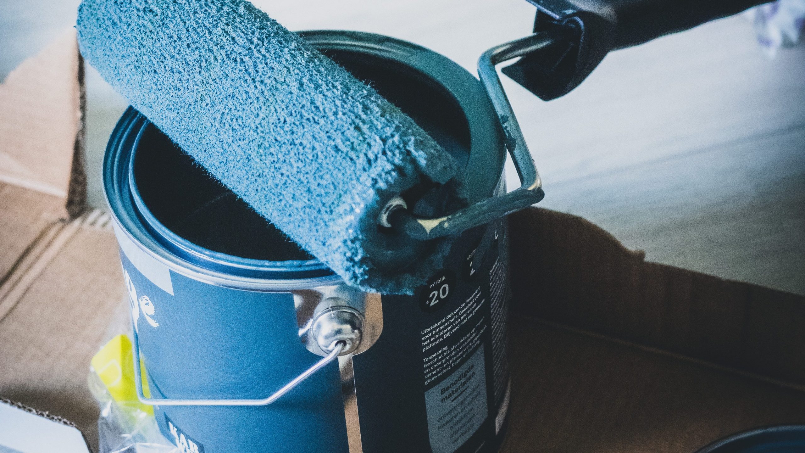 a paint can with a roller sitting on it, used to illustrate the Volatile Organic Compounds that evaporate out of drying paints and finishes.